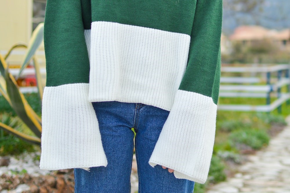 Woman wearing a green and white sweater