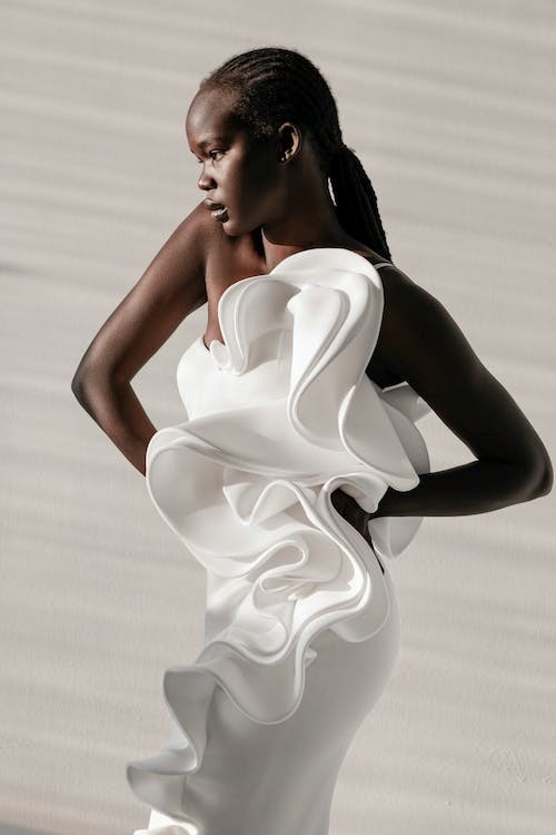 Female model in white dress with ruffles
