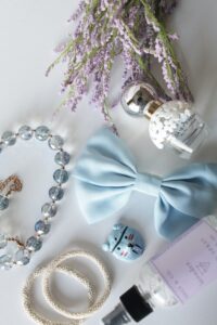 Women's bracelets, perfumes, and a hair bow.